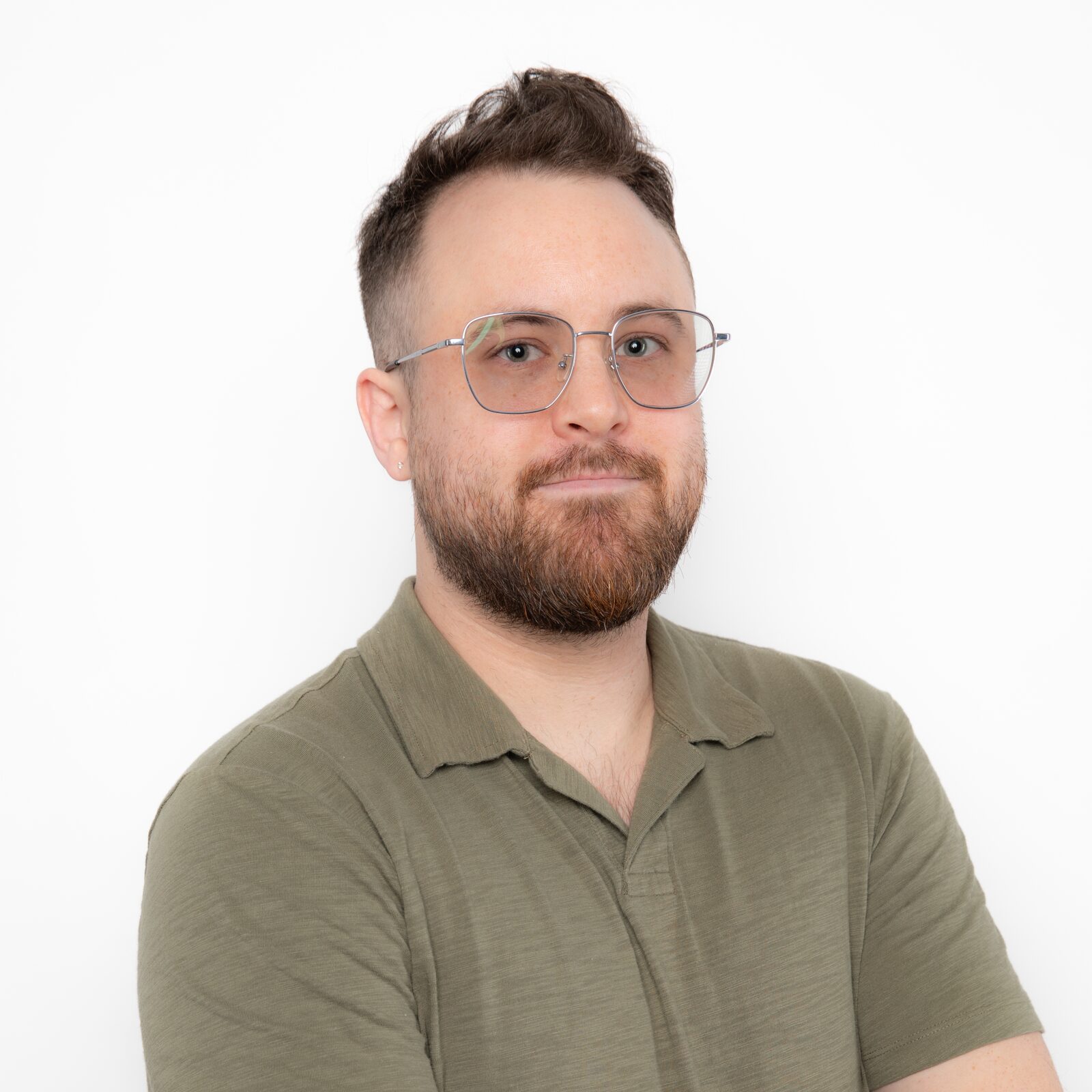 Brendan Larkin, bearded, in glasses and an olive polo shirt