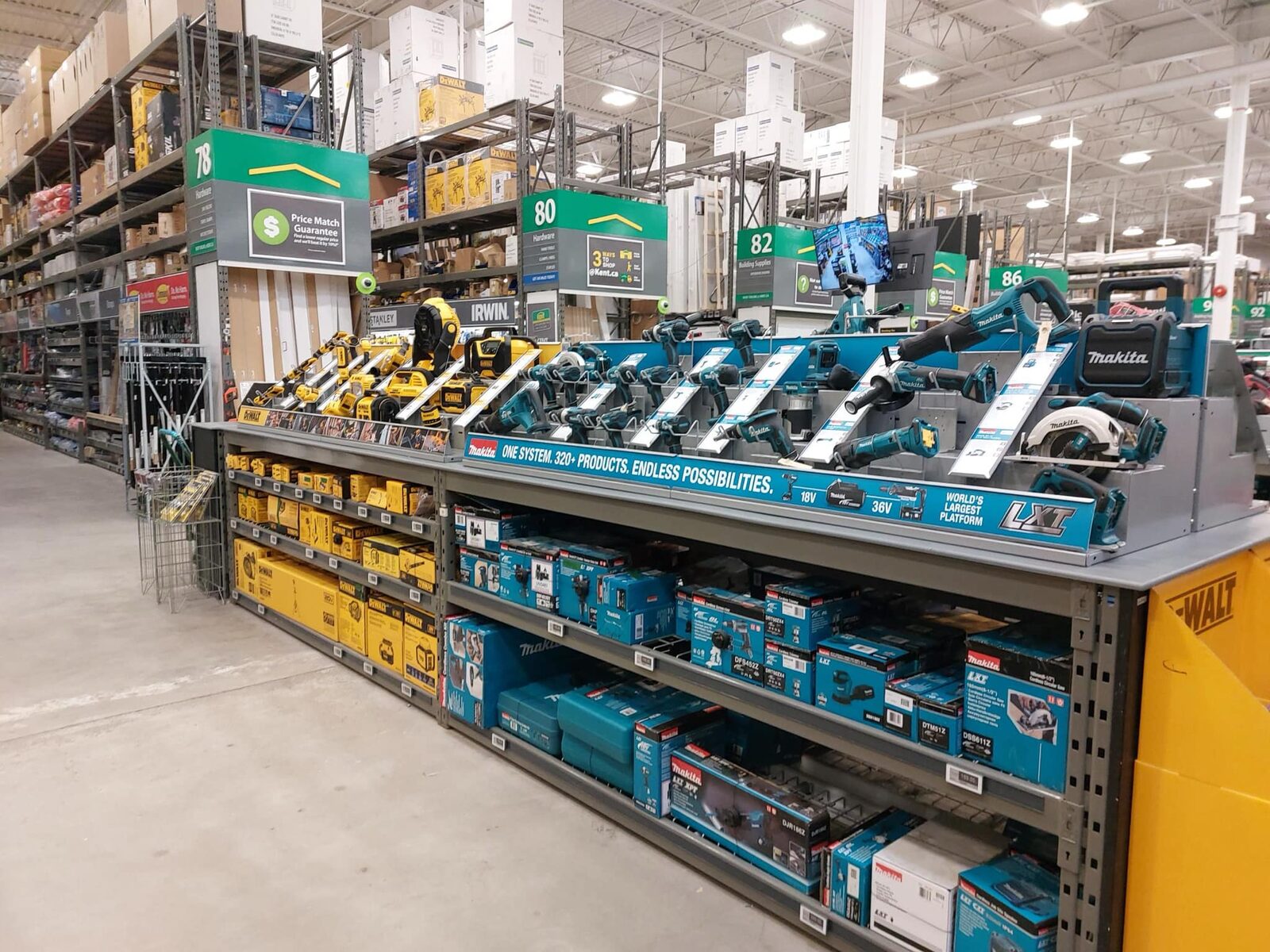 DeWalt and Makita tools on adjoining display decks, with matching boxed product shelved below