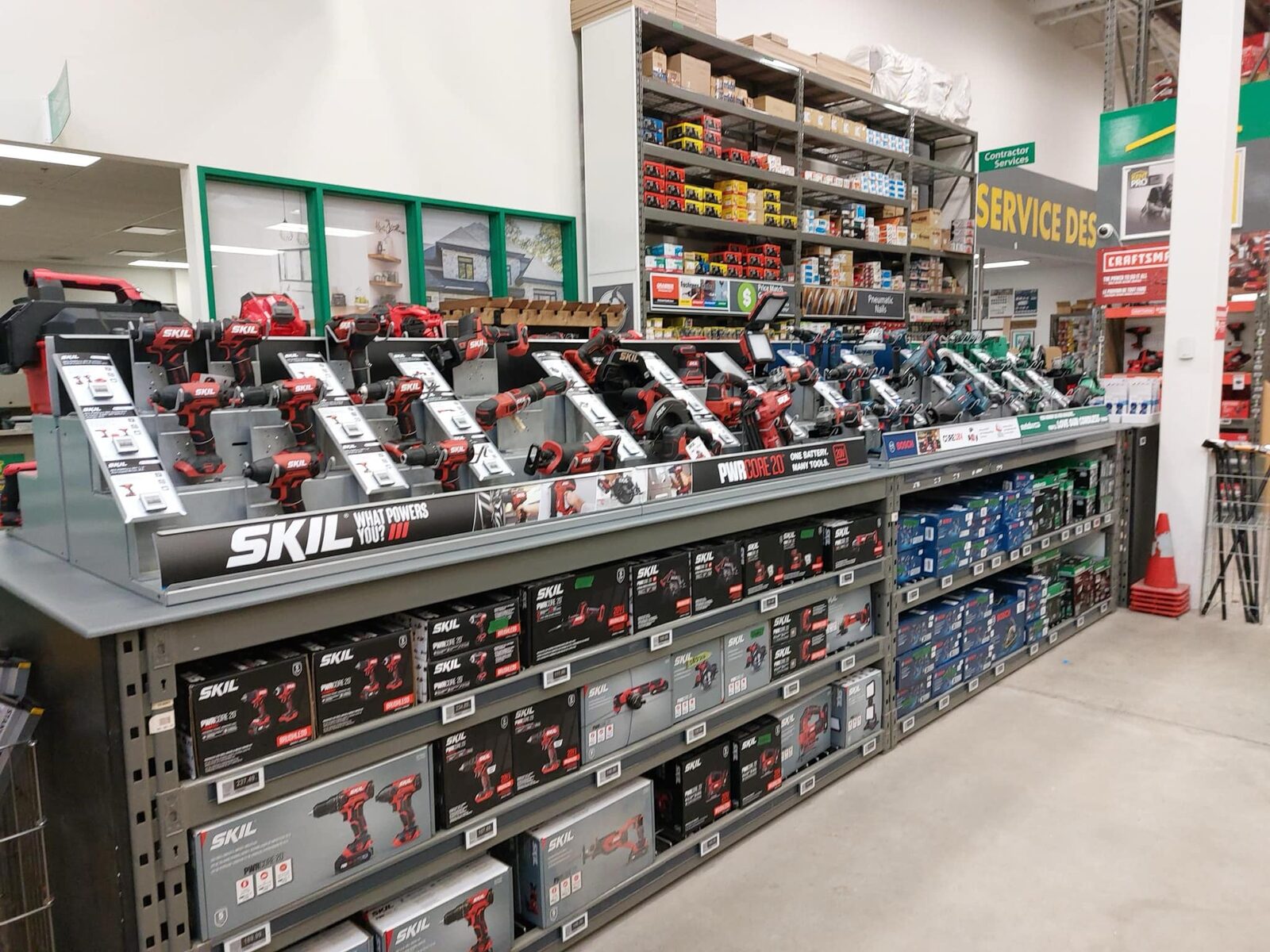 SKIL tools on the display deck near the Kent service desk, boxed stock shelved beneath